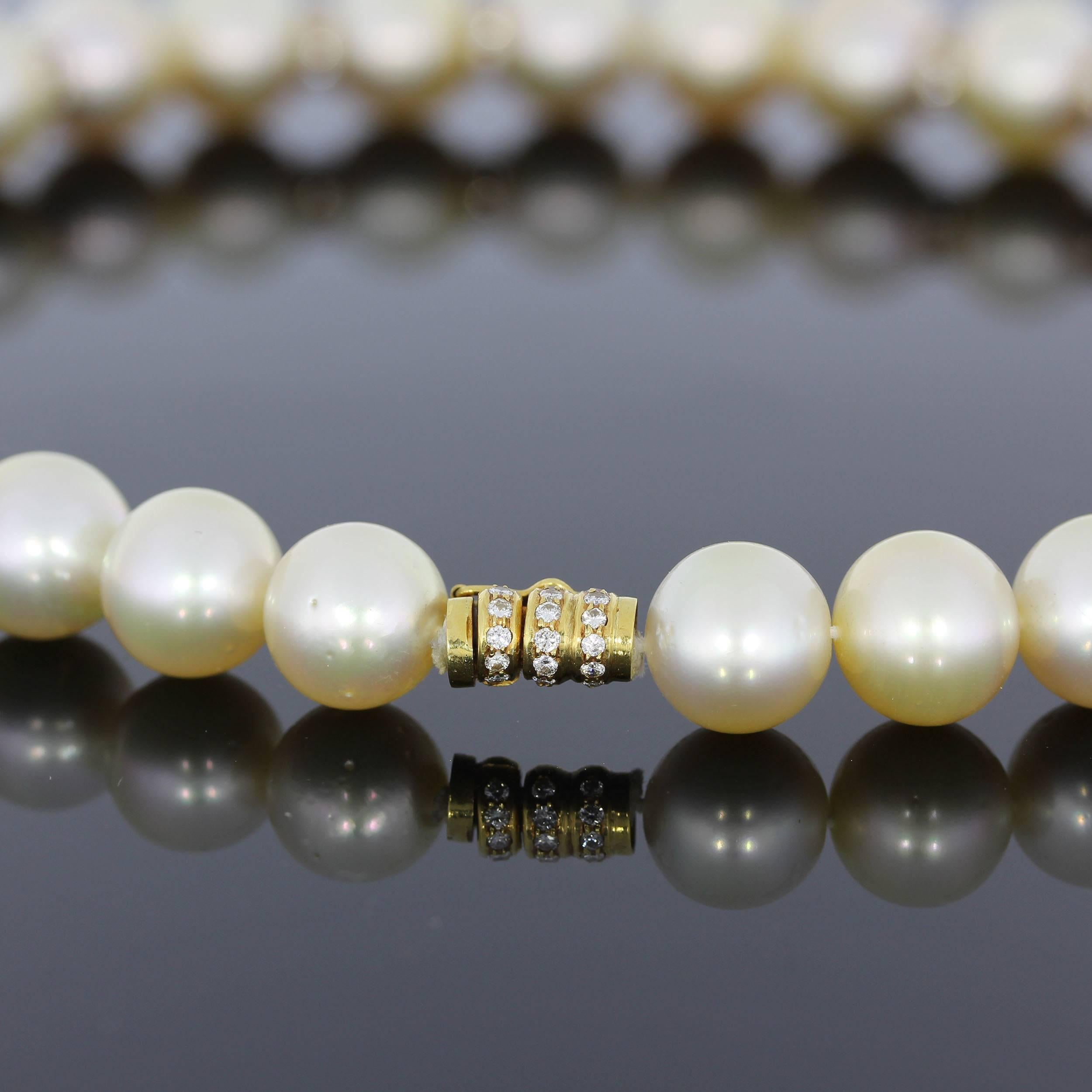 33 South Sea pearls with gold luster, diameter: 0.55 in ( 14 mm ). Between some pearls are setted diamond rondelle. 219 diamonds circa 5,74 carats. Affixed with diamonds and gold clasp. Made in 18K yellow gold. Total weight 118,40 grams. Length