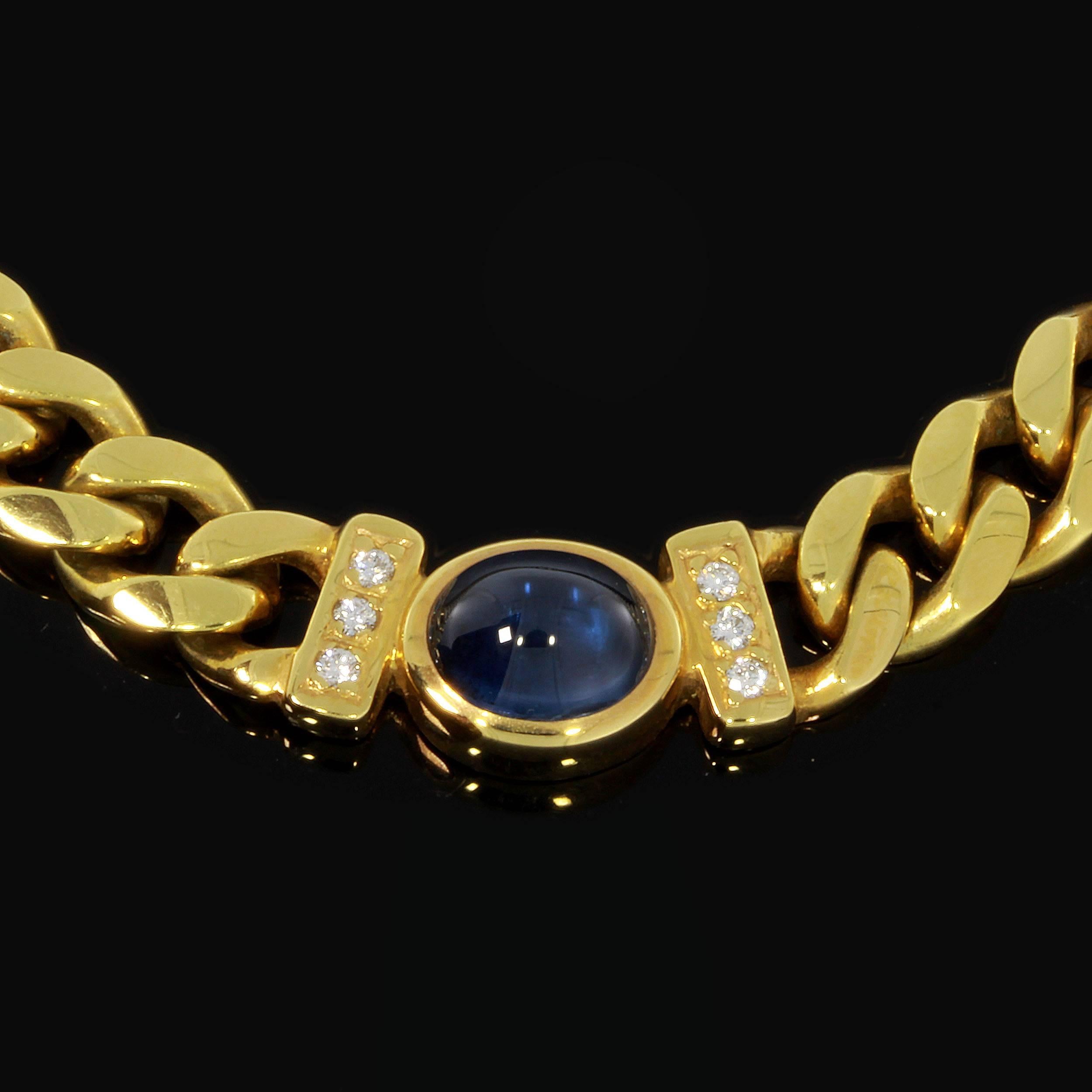 A beautiful design by Scheurle ( Quinn ), Schwäbisch Gmünd, Germany 1990s. 
Studded Necklace with a deep blue sapphire cabochon surrounded by 6 diamonds circa 0,15 carats and made in 14 K yellow gold. Signed: Quinn and hallmarked with the purity