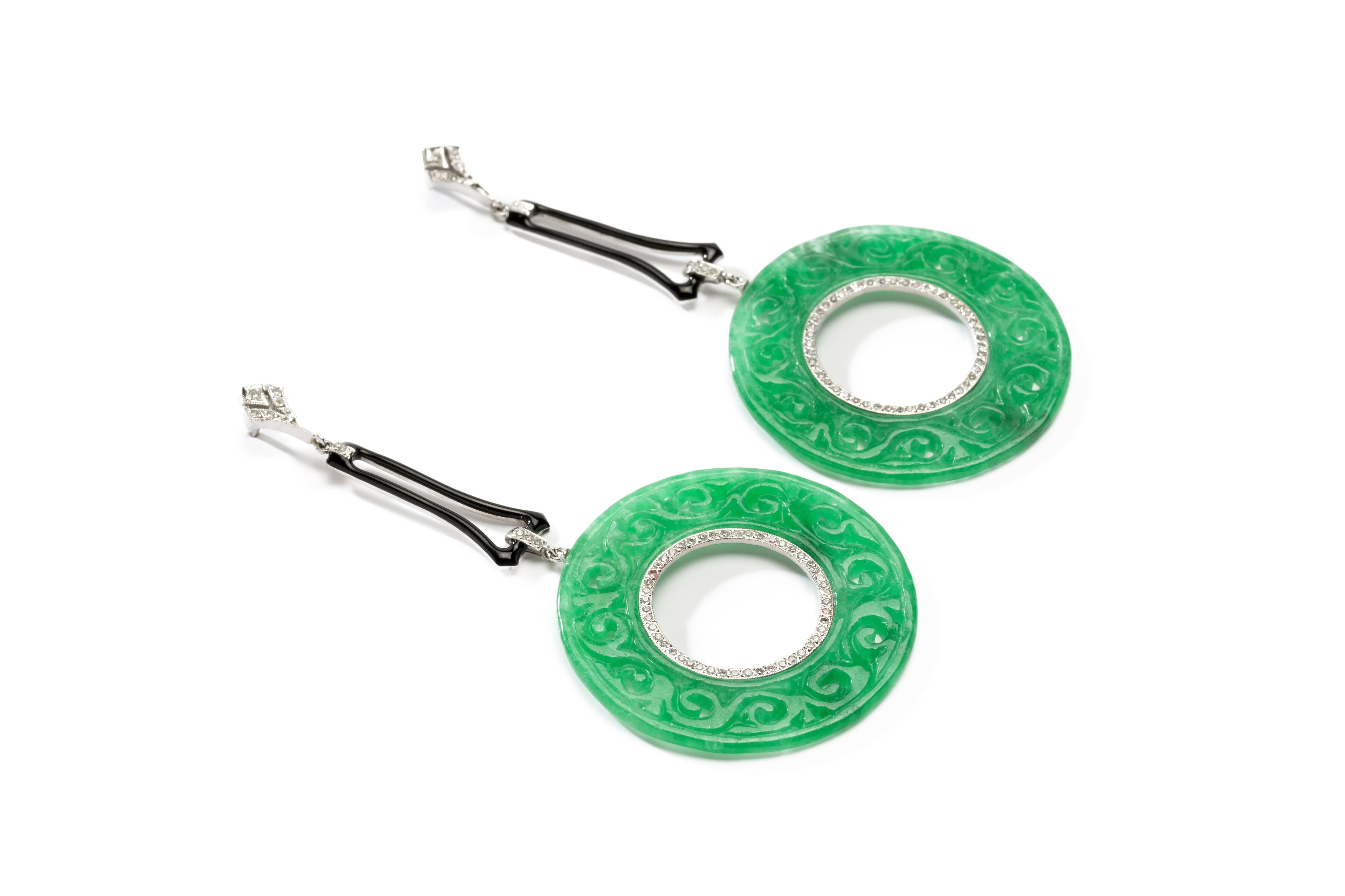 A pair of hand made earrings of 18 karat white gold with 112 diamonds in brilliant-cut weighing approximately 0,81 carats with large carved jade-creoles. Crafted ca. 2009. Enameled. Mounted in 18 K white gold. Weight: 10,01 grams. 
Length: 3.15 in (