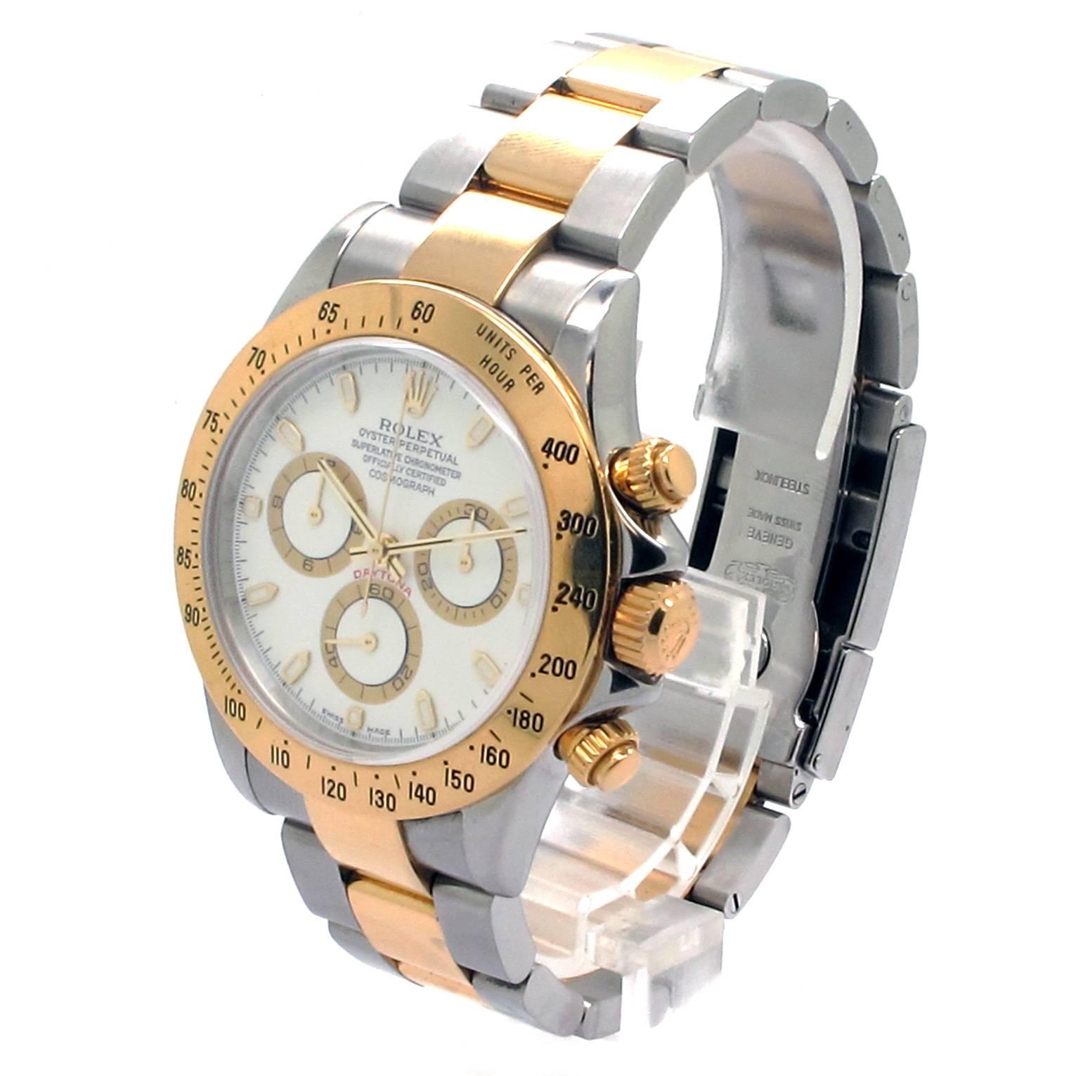 Rolex Daytona Cosmograph Two-Tone Men's Watch with a 40mm Stainless Steel Case. Fixed 18K Yellow Gold with engraved tachymetric scale Bezel. White Dial with luminous hands and Markers. 18K Yellow Gold and Stainless Steel Oyster Bracelet with Folding