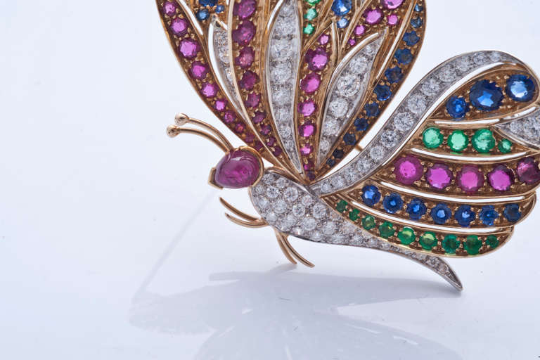 A wonderful yellow and white 18k gold, diamonds, rubies, sapphires and emeralds Butterfly brooch. Made in 1950 circa, in Italy.