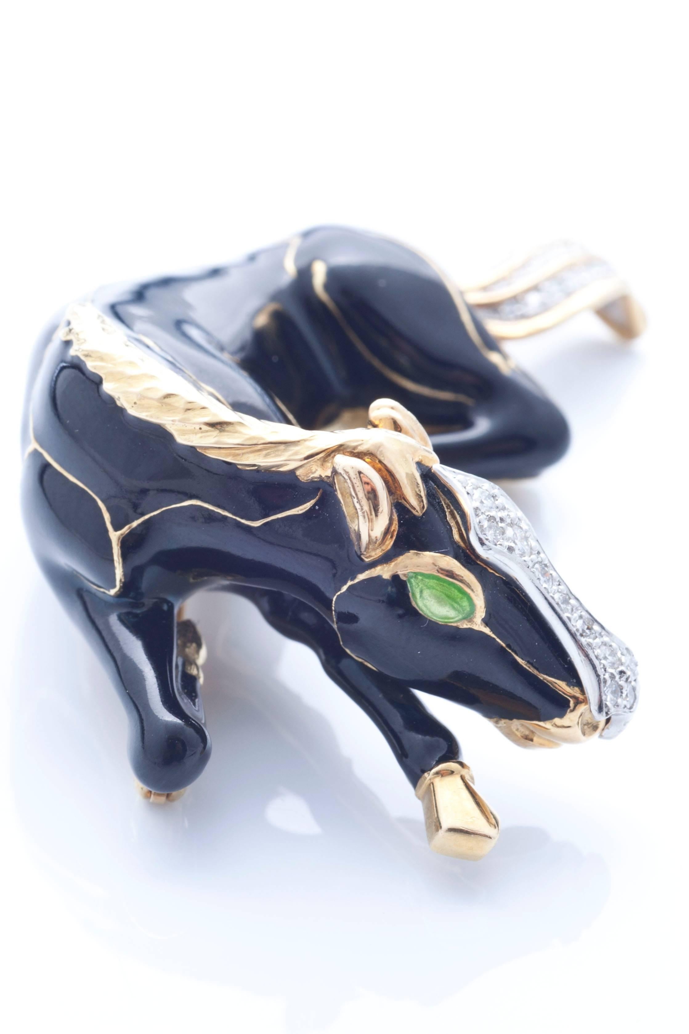 Black enamel horse with cabochon emeral eyes and circular-cut diamond nose and tail detail, mounted in platinum and 18k yellow gold brooch. Signed Webb

