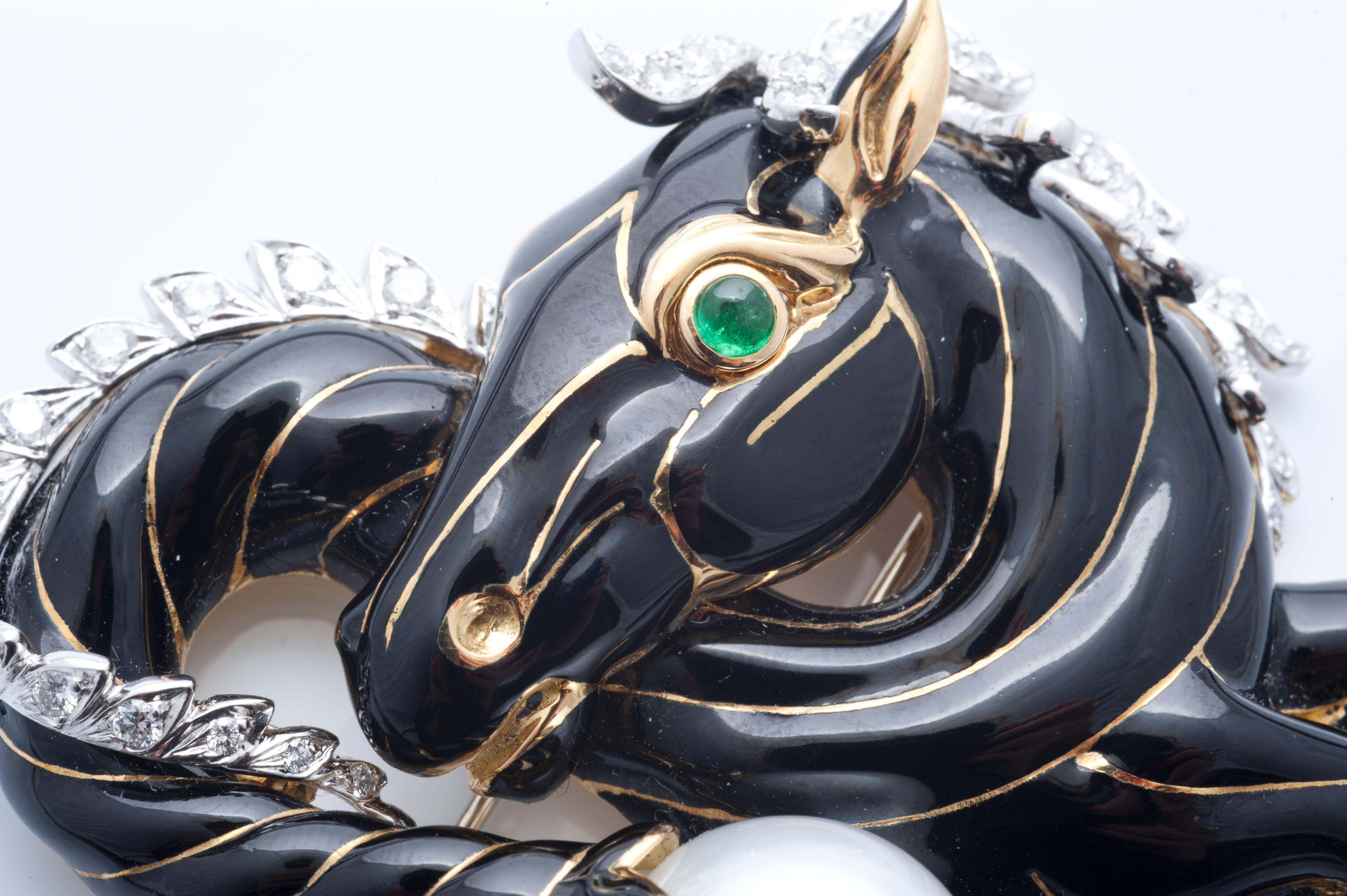 Black enamel horse, with circular-cut emeral eye, diamond mane and a South Sea pearl, mounted in platinum and 18k gold. Signed David Webb
