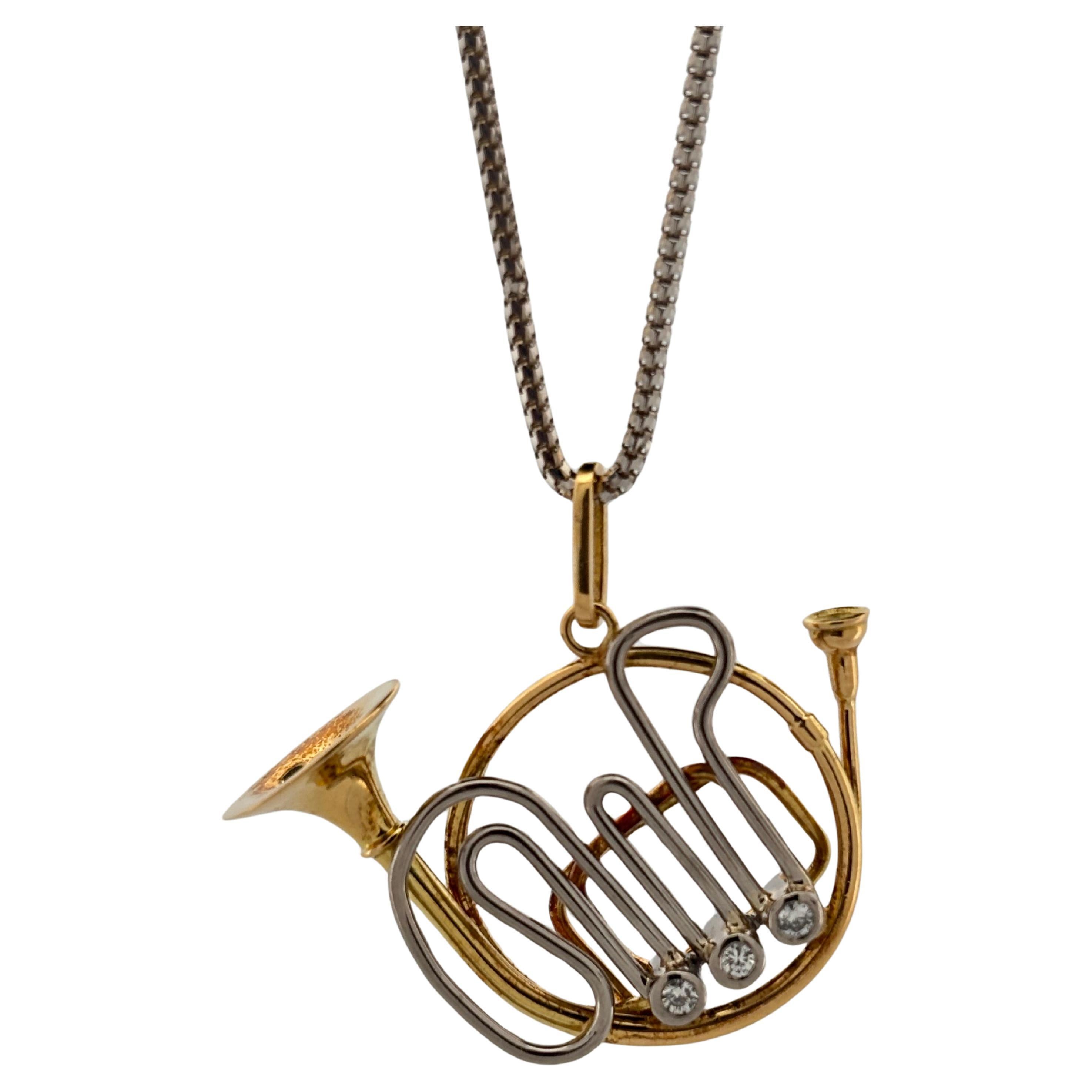 Celebrate musical artistry with this whimsical and refined French horn pendant, masterfully crafted in 18K yellow gold and platinum. Designed in the shape of a Japanese-style French horn, this charming piece features intricate tubing details