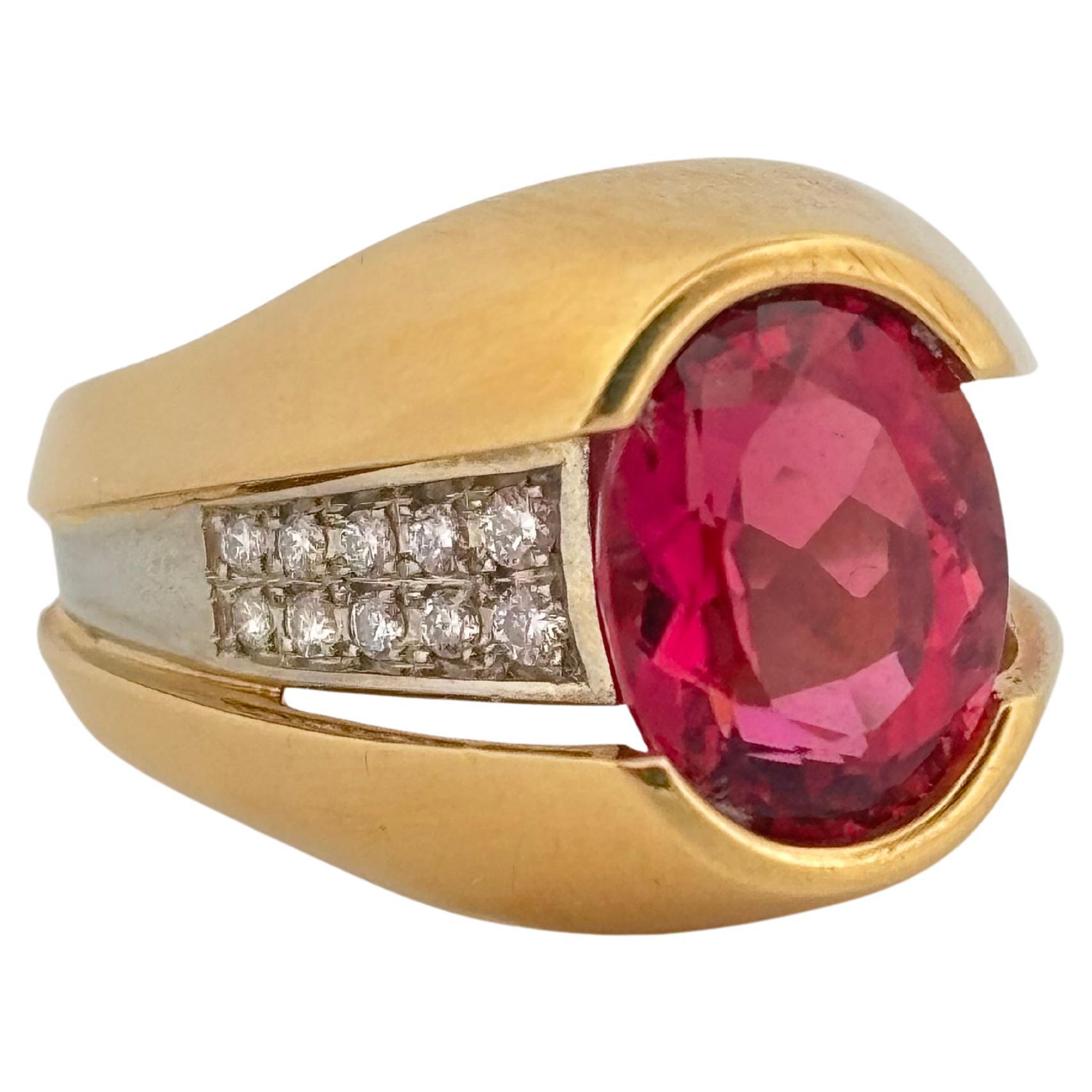 Striking in both form and color, this 18K yellow gold and platinum ring weighing 11.8 grams, features a captivating 3.50 carat oval-cut pink morganite as its vibrant centerpiece. The gem’s soft blush hue is beautifully enhanced by a bold, sculptural