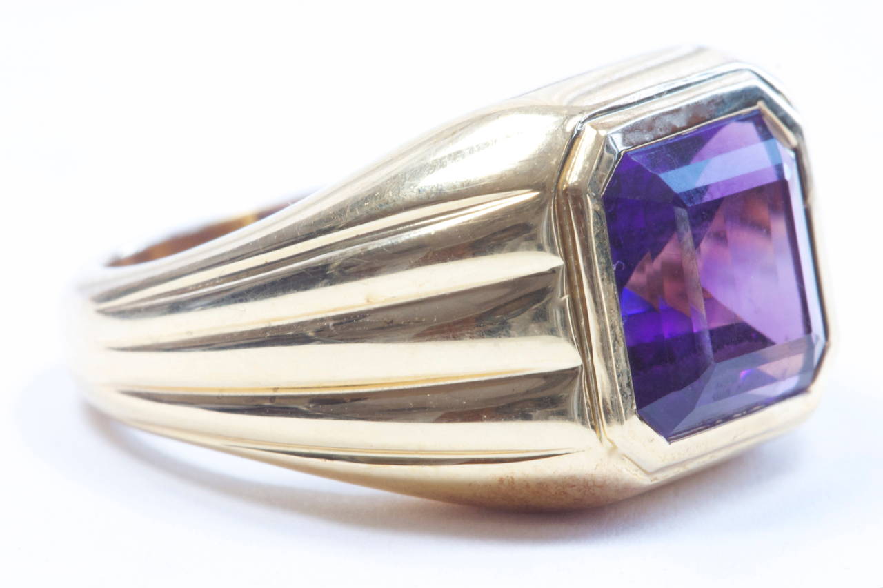 A well designed square cut amethyst ring. The deep purple amethyst has been bezel set in 18k yellow gold with a sleek and stylish set of lines flowing down each side of the ring. Created by a French jeweler with French hallmarks.

Size 6 1/4 and