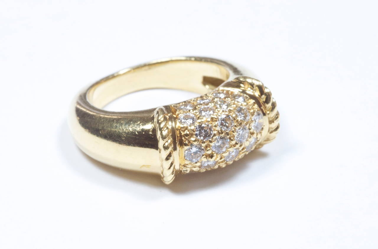 The classic Phillippine design from Van Cleef and Arpels. The clean, white diamonds have been pave set at the focal point of the ring and is accented by fluted rope motif 18k yellow gold. What makes the ring rare is that VCA no longer manufactures