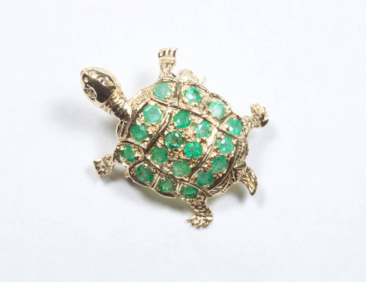 This adorable mini turtle is decorated with 19 forest green round cut emeralds bringing the shell to life with color. The dimensions of the turtle are 1