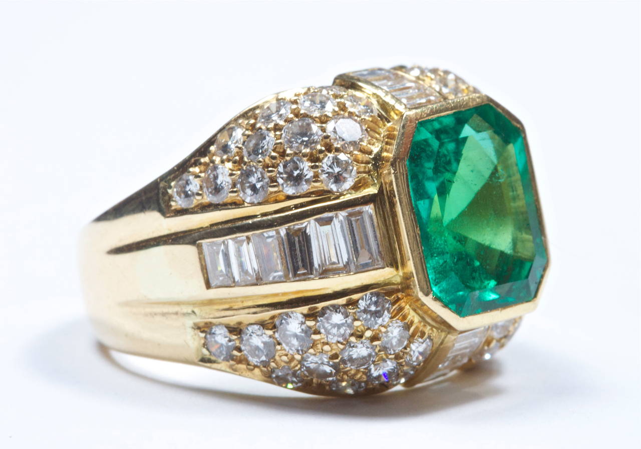 The Colombian emerald weighs approximately 3.80 carats and is set in an 18k gold ring. The emerald is a vibrant green color with few clarity characteristics. The ring is accompanied with a GIA certificate. 
The ring has 18 baguette cut diamonds