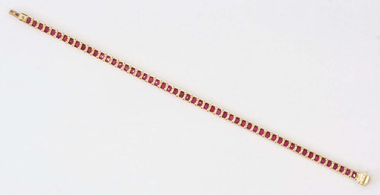 This fabulous bracelet is designed with 10.59 carats of french cut vibrant red rubies. The bracelet is 7 inches long and is crafted out of 18k yellow gold. Easy and comfortable to wear.
