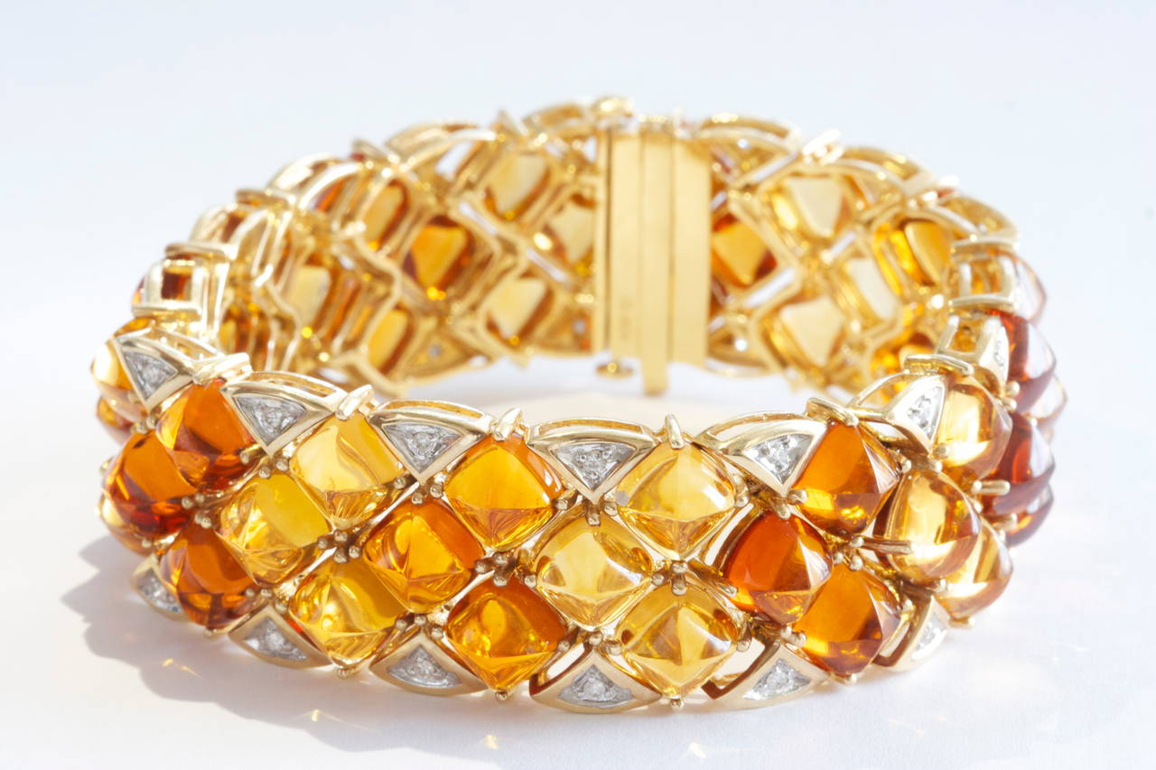 A classic retro bracelet that has all the characteristics typical of this time era; big, colorful and fun. With a mixture of square cut cabochon citrine's that display many different orange hues and has been perfectly complimented by an outer