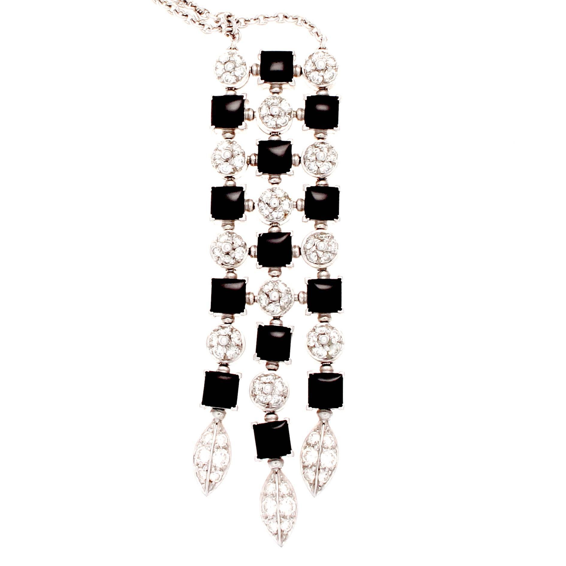 A modernistic creation by the Italian designers at Bulgari. The necklace has been fashioned with alternating shaped of jet black onyx and clean white diamonds. Creatively crafted with 4 beads that grasp the clasp so the necklace can be worn at