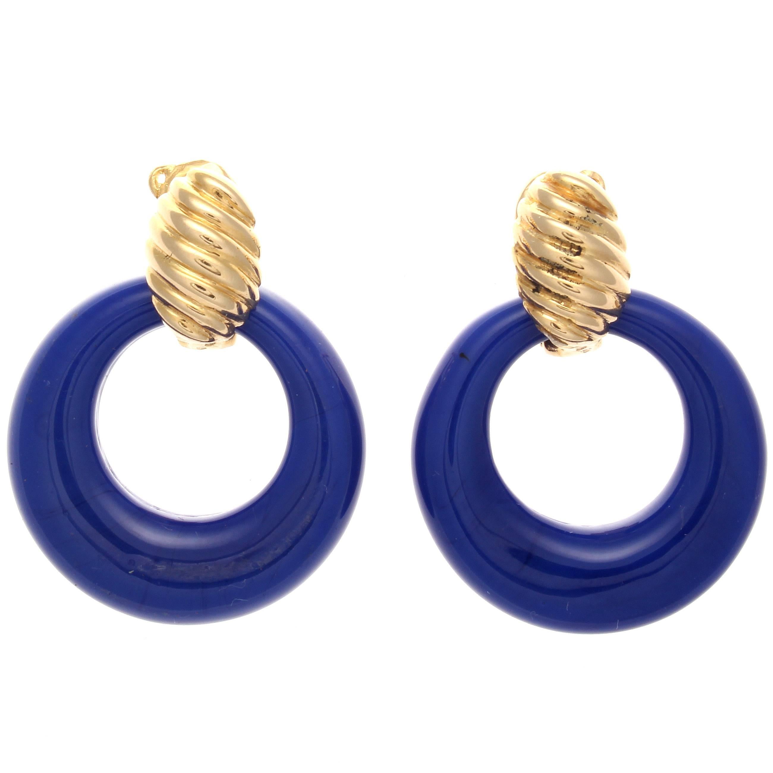 An intelligent chameleon design from Van Cleef & Arpels that features interchangeable door knocker earrings. Featuring hoops of royal blue chalcedony, jet black onyx and glistening 18k yellow gold. Signed VCA and numbered. 