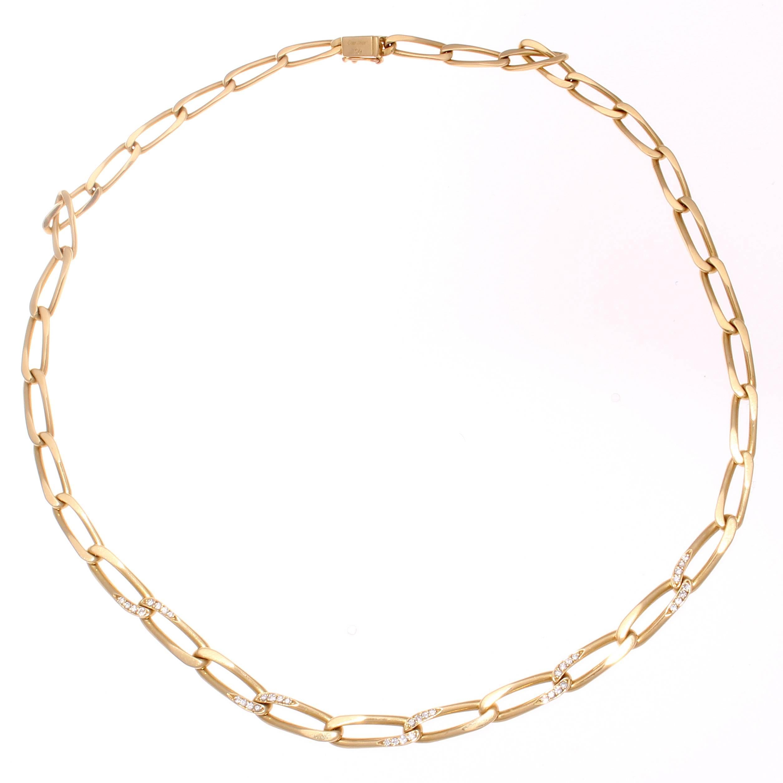 The true elegance from Cartier is subtly portrayed through the gently interlocking links of gold that are thoughtfully designed with white, clean diamonds. Crafted in 18k yellow gold. Signed Cartier and numbered.
