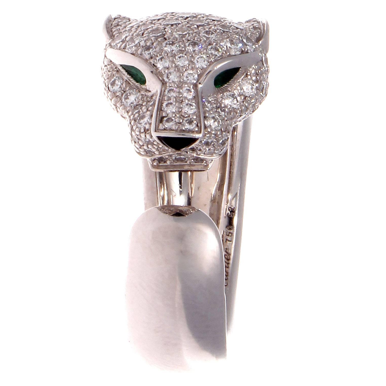 The panthere has been a staple of Cartier since 1914 and the collection has featured the panthere in its many elusive forms. Created with numerous pave set diamonds covering its head and featuring bright green emerald eyes with an onyx nose. Signed