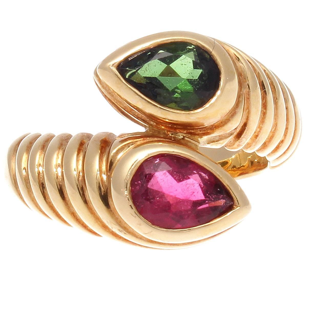 Celebrating opulence and color in the 1980's and 1990's Bulgari's designs were unforgettable and still remain popular today. Created with vibrant green tourmaline overlapping with the rich red tourmaline. Set amid rolling contours of 18k yellow