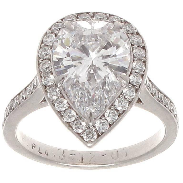 A lovely modern creation on the forever classic diamond engagement ring. Featuring a GIA certified 2.31 carat pear shaped diamond that is D color, VS2 clarity. Surrounded by a halo of perfectly matching clean white round cut diamonds. Crafted in
