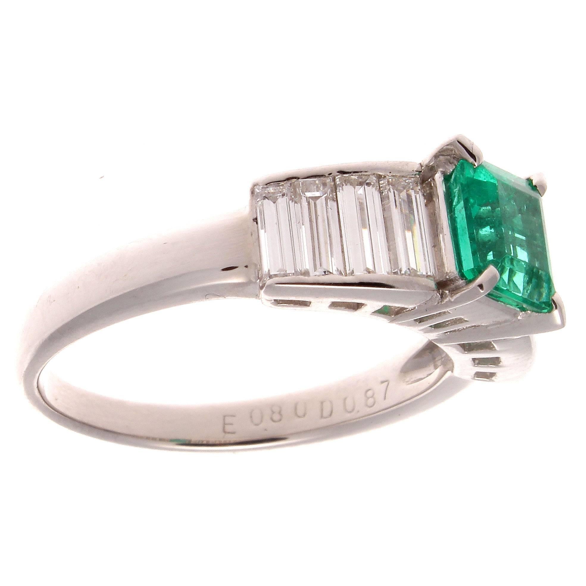 A unique and stunning engagement ring. The rich forest green Colombian emerald weighs 0.80 carats and the 8 accenting white emerald cut diamonds weigh 0.87 carats. In platinum.

Ring size 6 and may be re-sized to fit.