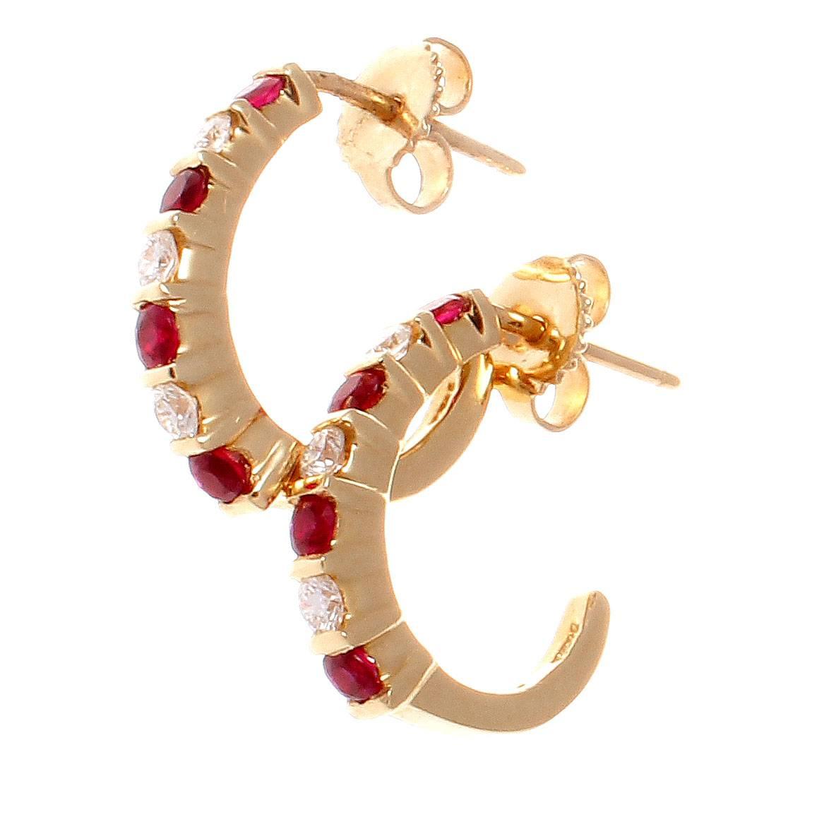 A colorful representation of the classic pairing of red rubies and yellow gold. Subtle, elegant and delicate. Featuring alternating colorless diamonds with vibrant red rubies cascading down the 14k gold hoop earrings.