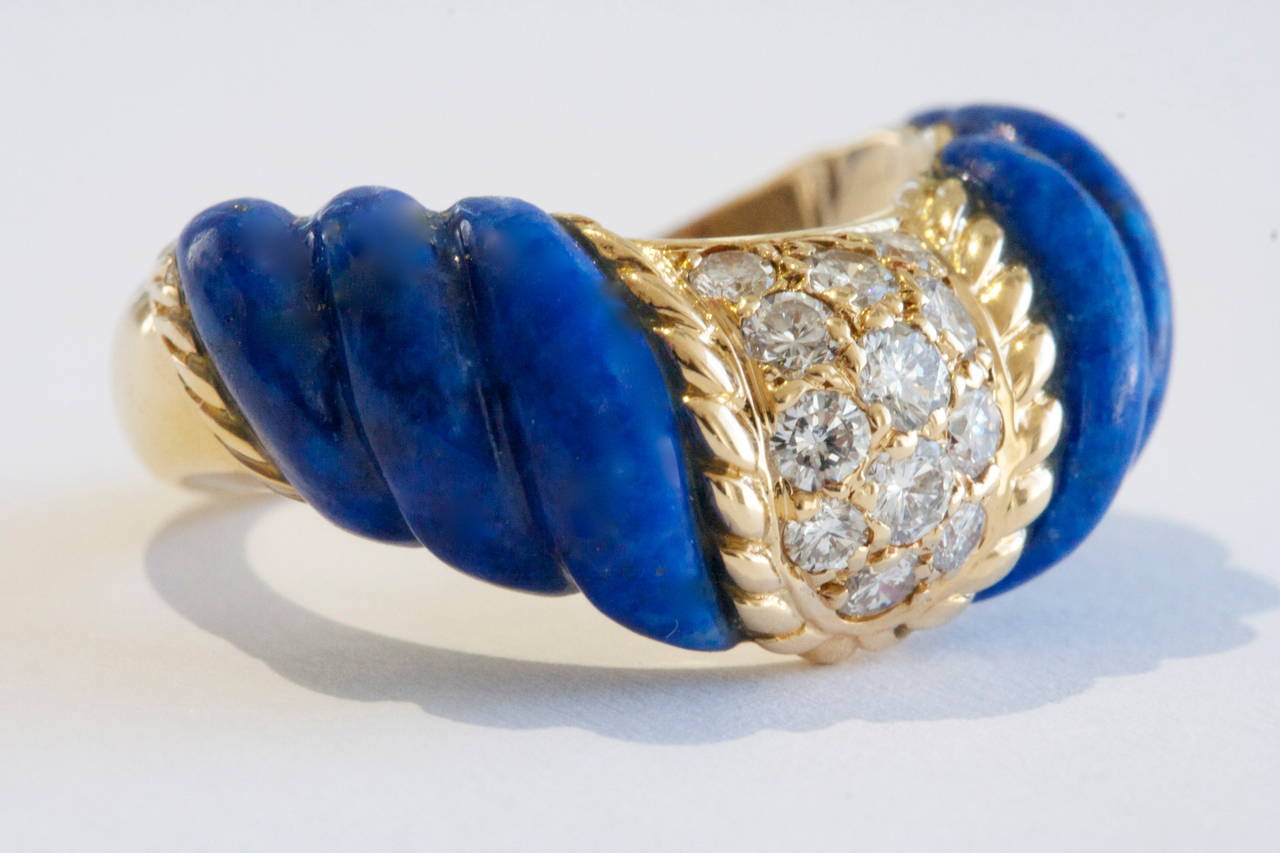 A bright color combination from Boucheron Paris. Combining rolling hills of Lapis Lazuli with yellow gold. The diamonds are white F,G color and VS1 quality. Hand made 18k gold ring.

Signed Boucheron Paris, with serial numbers.

Size 6 and can