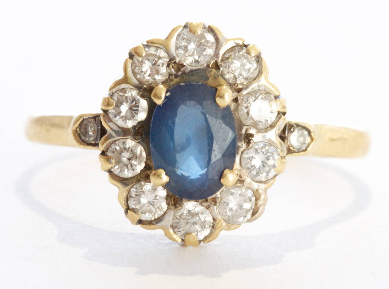 A charming Belle Epoque Sapphire Diamond halo engagement ring. The center blue sapphire weighs approximately 1.50 carats and is surrounded by a halo of white old cut diamonds. Crafted in 18k gold with French hallmarks.

Size 7 1/2 and can be