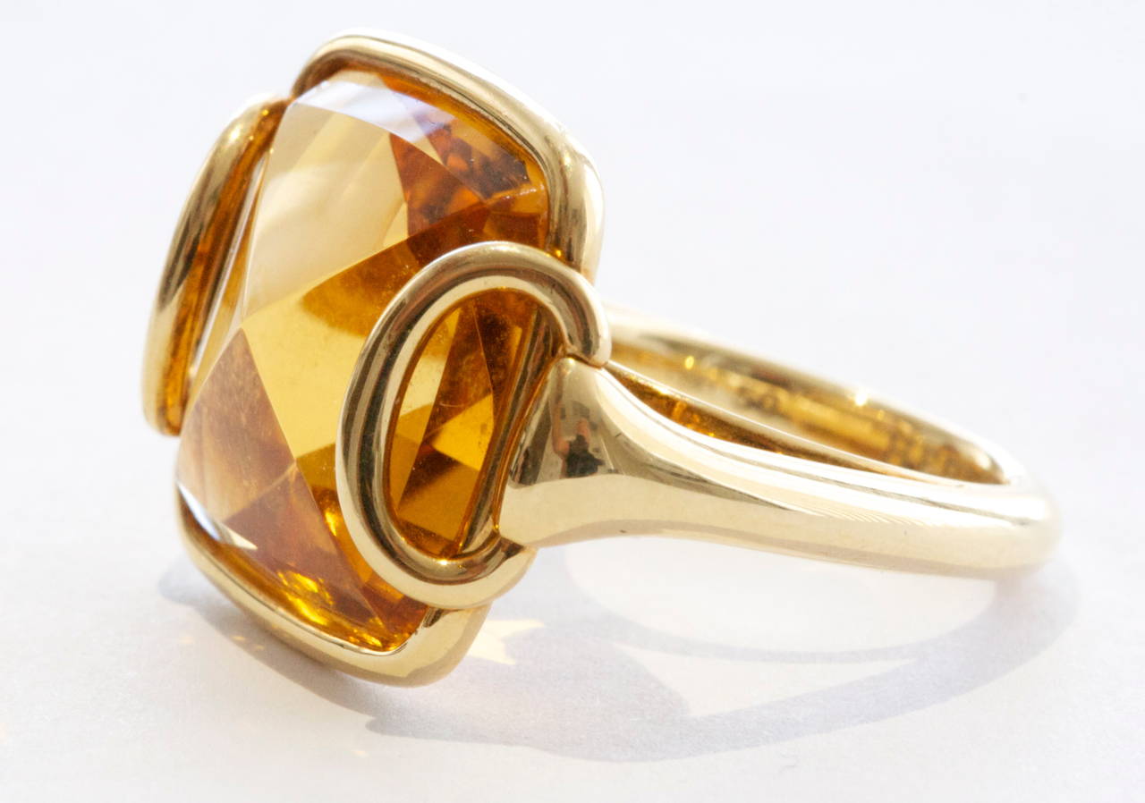 The highly sought after and always desirable buckle design from Hermes. A square cut cabochon pyramid citrine with deep orange  color, fastened by the ubiquitous Hermes buckle.  Hand crafted in 18k yellow gold. 

Signed Hermes with serial