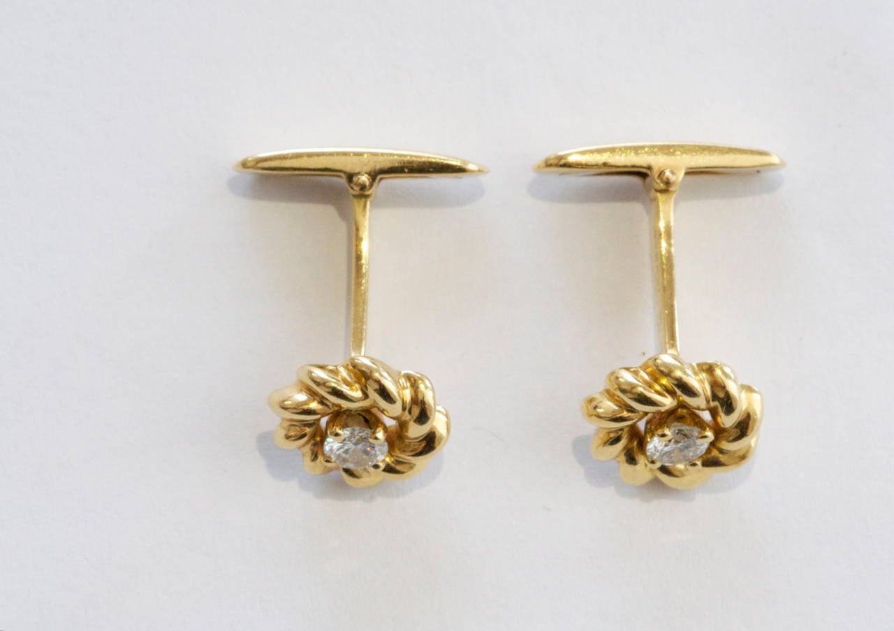 France has always been recognized for its style and fashion and the jewelry created there is no exception. The cufflinks have been designed with two near colorless diamonds that have been encircled by rolling waves of 18k yellow gold. Signed Chaumet