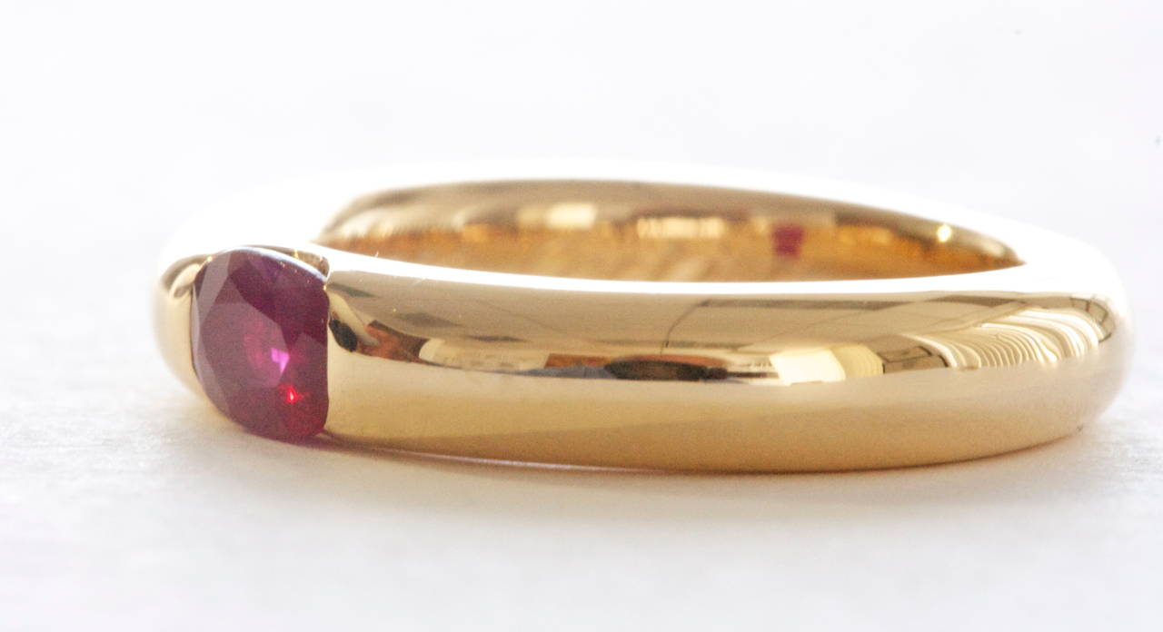 From the Cartier Elipse collection. A simple and elegantly smooth design featuring a 0.50 carat ruby bezel set in 18k yellow gold. 

Signed Cartier with serial number and date of 1992. Stamped with French hallmarks.

Size 50 or 5-1/2