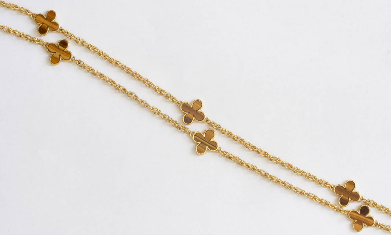 Gucci is known for its fashionable sense of style. Here they have created an 8 clover motif necklace designed with tigers eye. The chain is 32 inches long. It can be fashioned as a long elegant necklace or it can be doubled. In 18k gold.

Signed