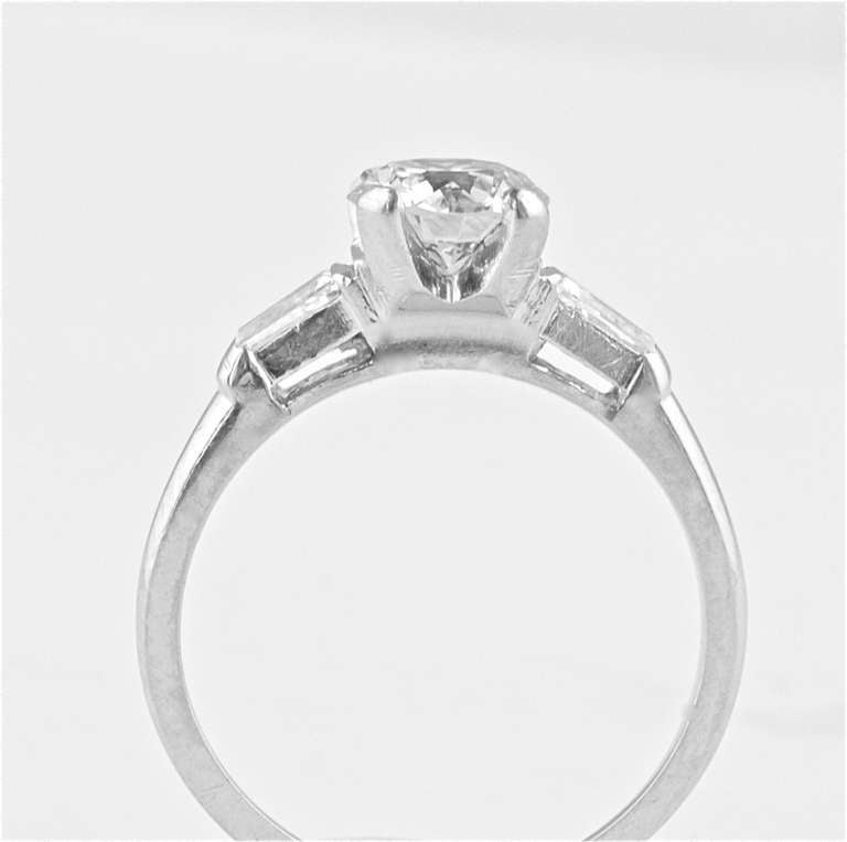 The diamond is EGL certified as J color and SI2 clarity. The weight is 0.99 carats.With 2 tapered baguettes as accents and set in a 14k white gold ring.

Ring size 6 and can be re-sized