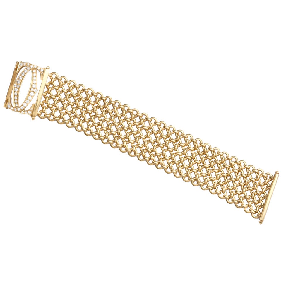The Cartier mid-size Penelope Double C Diamond link/mesh bracelet. Designed with 42 white, clean and well matched diamonds covering the entirety of the double C's in the clasp. The bracelet itself is 5 rows of mesh looking 18k yellow gold that is