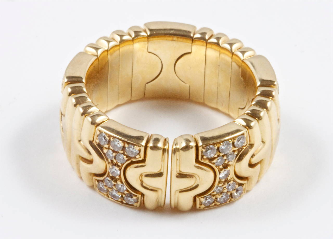 A delicate and symmetrical design from  Bulgari. The ring has been created with carved 18k gold and separated spatially with hour glasses of white, clean diamonds. Signed Bvlgari and numbered.

Ring size 6
