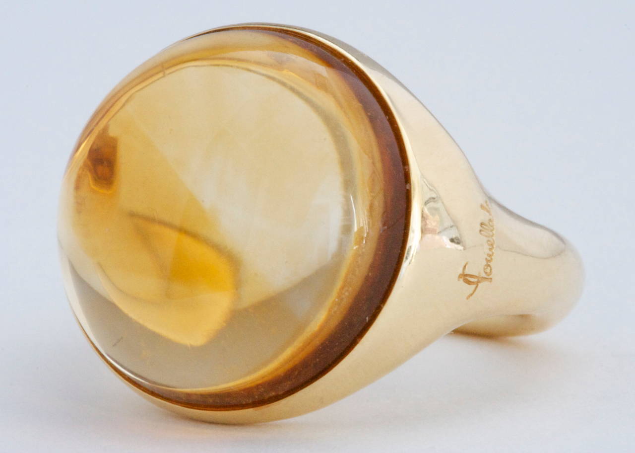 An identifiable design from the striking Italian creators at Pomellato. Moving forward with their modern and unique designs is a cabochon golden citrine that is  bezel set in a hand crafted 18k gold ring.

Signed Pomellato and numbered.

Ring