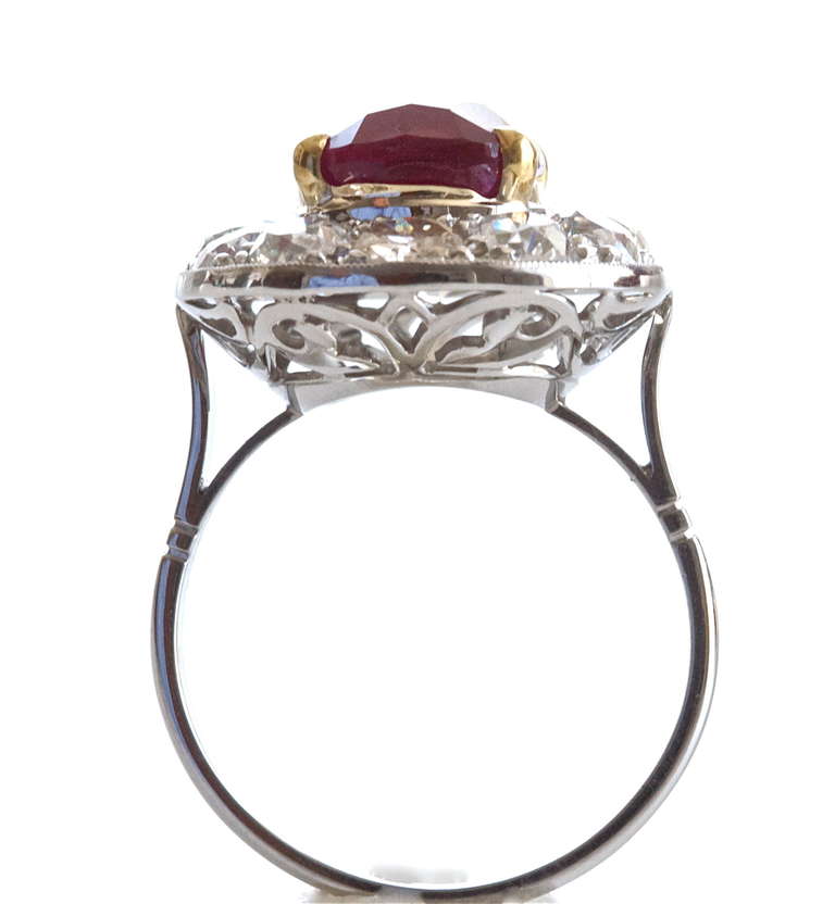Beautiful pigeon blood natural ruby weighing 6.51. In a hand made platinum ring with 12 diamonds weighing approximately 2 carats. Accompanied by GIA certificate. 

Ring size 6 1/2 and can be re-sized.
