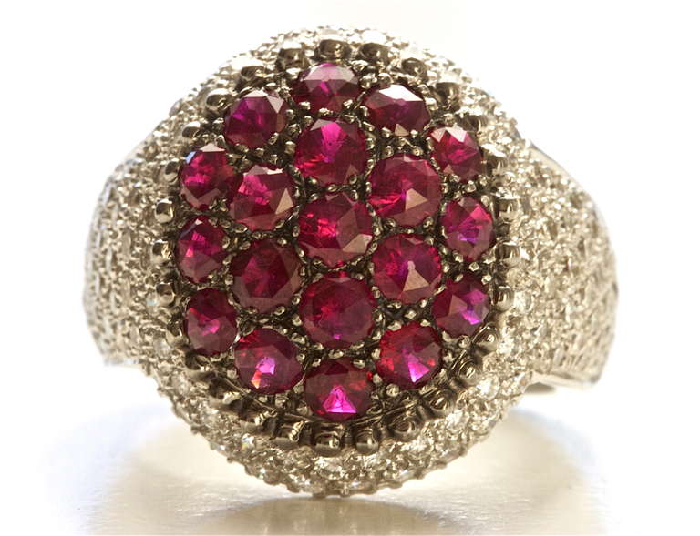 From the house of Mouawad. Beautiful red rubies and top quality diamonds expertly set in a 18k gold ring.

Size 7 and can be re-sized