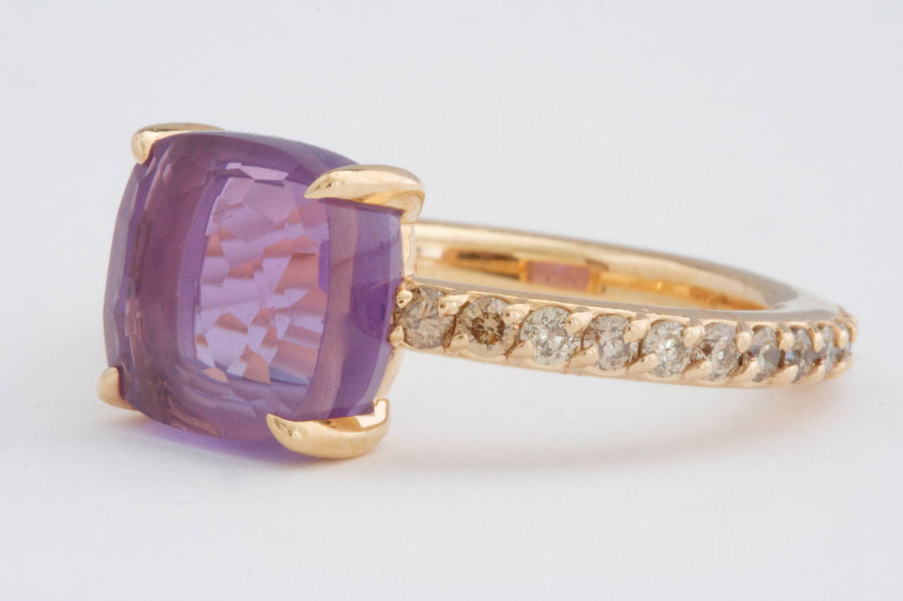 A clean and vibrant look from  Pomellato. Designed with cognac diamonds that go all the way around the band to feature a lovely purple faceted amethyst. Crafted in 18k Gold and signed Pomellato.

Size 6-3/4

Please contact us if you are