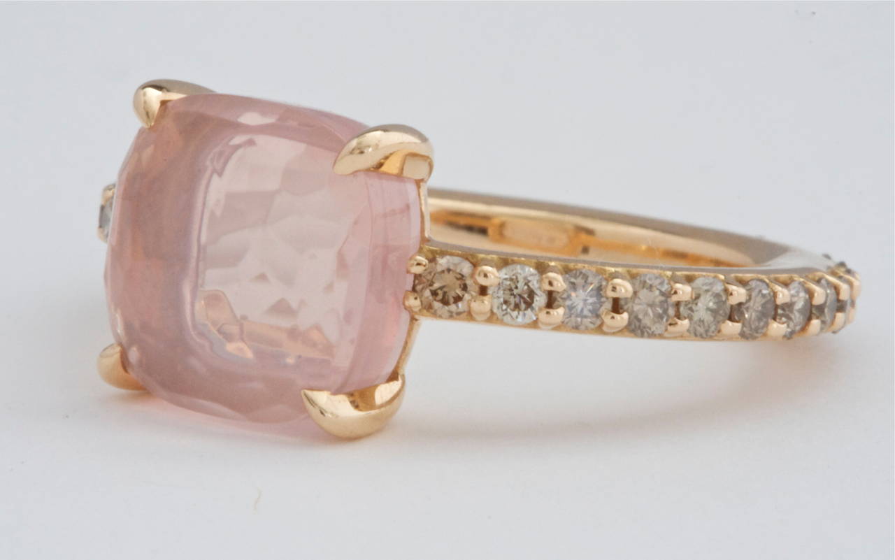 A clean and vibrant look from  Pomellato. Designed with cognac diamonds that go all the way around the band and featuring a pink faceted quartz gemstone. Crafted in 18k Gold and signed Pomellato.

Size 6-1/2

Please contact us if you are