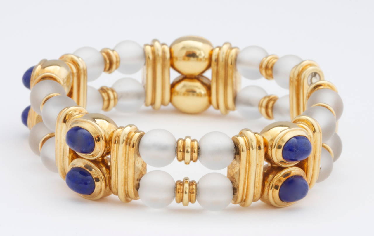 A creation from the French designers at Boucheron that features color and intricate gold work. The bracelet has been made with cabochon blue lapis and supplemented by perfectly spherical balls of rock crystal that have been separated by 3 rows of
