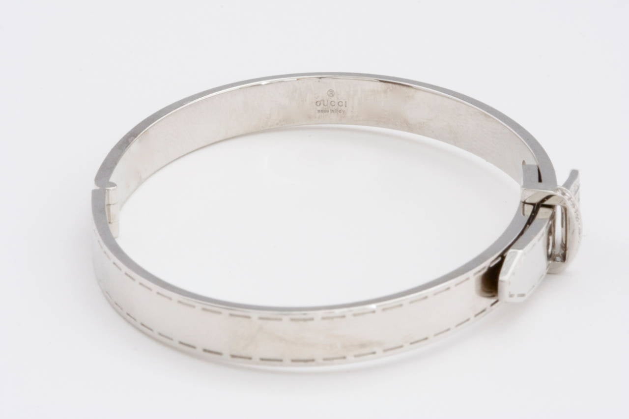 The fashion forward Gucci designers have created a lovely white gold diamond buckle bracelet. Bringing this motif to life they have designed the bracelet with stitching all the way around and pave set diamonds in the buckle. 

Signed
