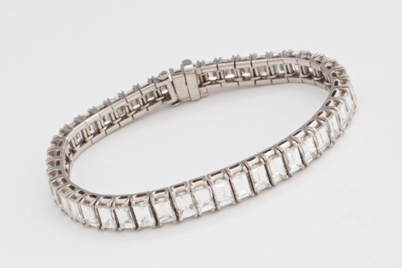 This design is exquisitely simple. The bracelet is well made and created with perfectly matching emerald cut diamonds. There are 45 diamonds weighing approximately 20 carats, E,F in color and VVS, VS  in clarity. 

Hand crafted and delicately set