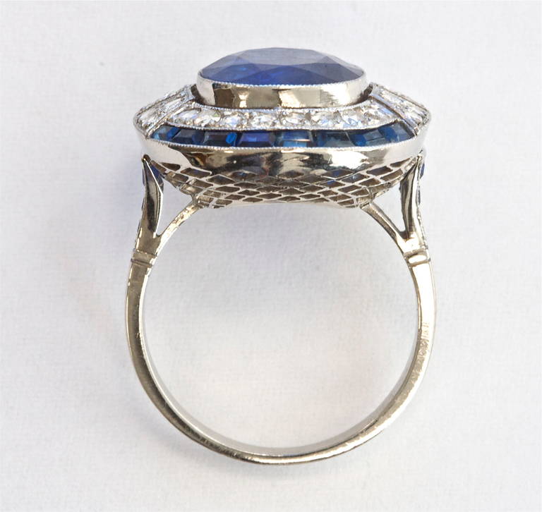 Beautiful Burma blue. In a hand crafted platinum ring with carre cut sapphires and diamonds. AGL certificate states the sapphire is of Burma origin with no indications of heating or other treatment.

Ring size 6 and can be re-sized.