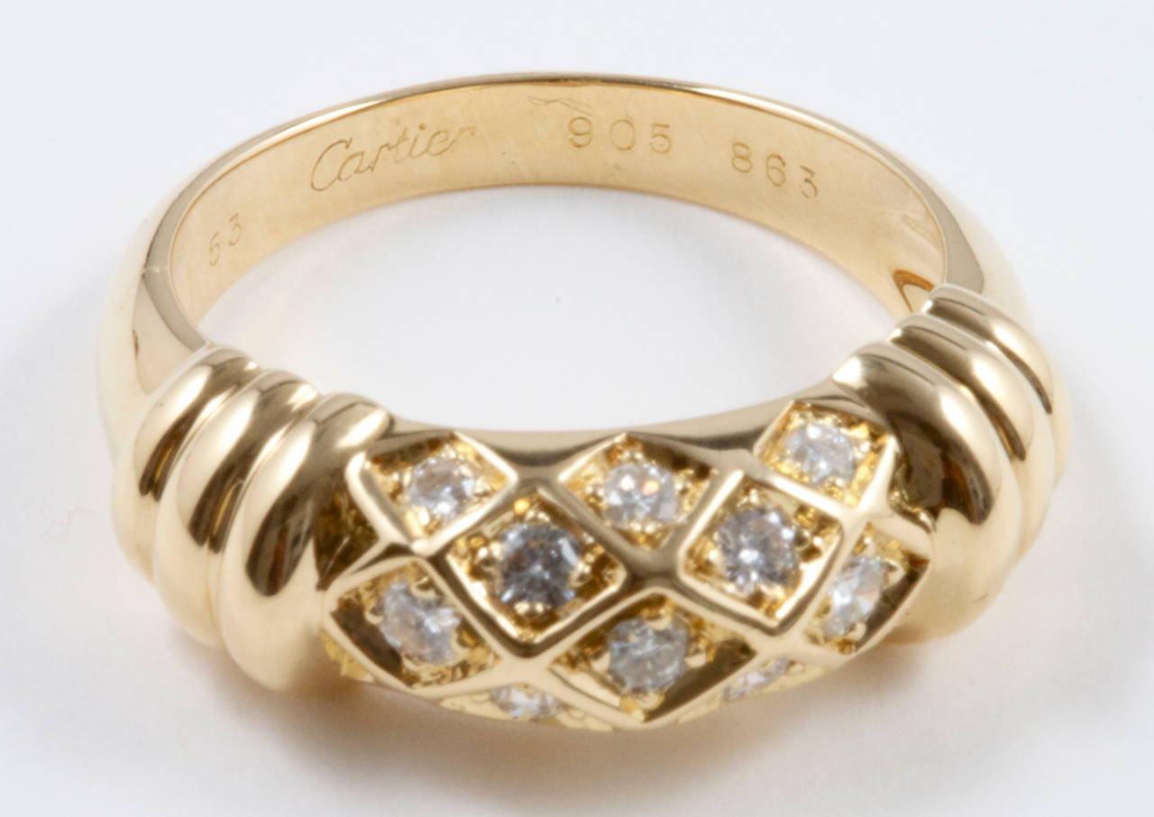 Cartier, elegant and timeless. The ring has been designed with numerous near colorless diamonds that have been carefully intertwined in the 18k yellow gold creating a honeycomb effect. Signed Cartier and numbered. 

Ring size 6-1/2 and may be