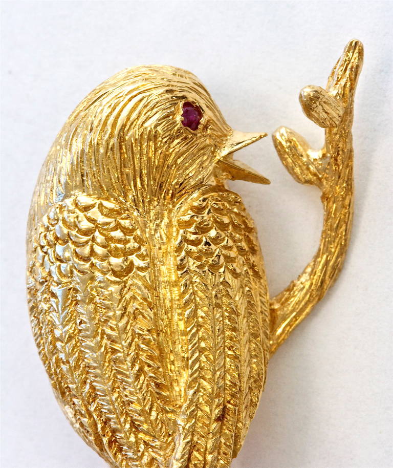 Exquisitely realized brooch. Boucheron Paris displaying the fabric like material they were so fond of replicating. With a ruby eye and in 18k gold.  Signed and numbered with French hallmarks.