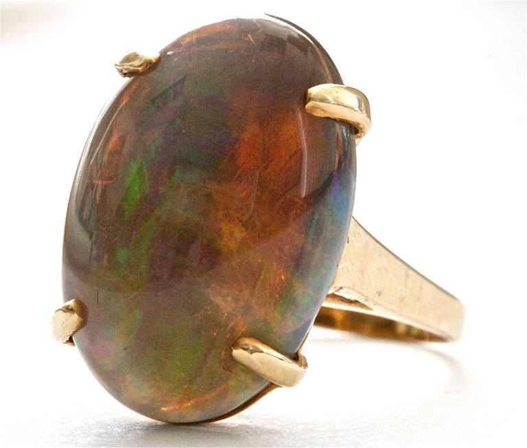 This unusual and colorful opal weighs approximately 14 carats and is set in a 14k gold ring.Very well priced.

Ring size 7 and can easily be re-sized.