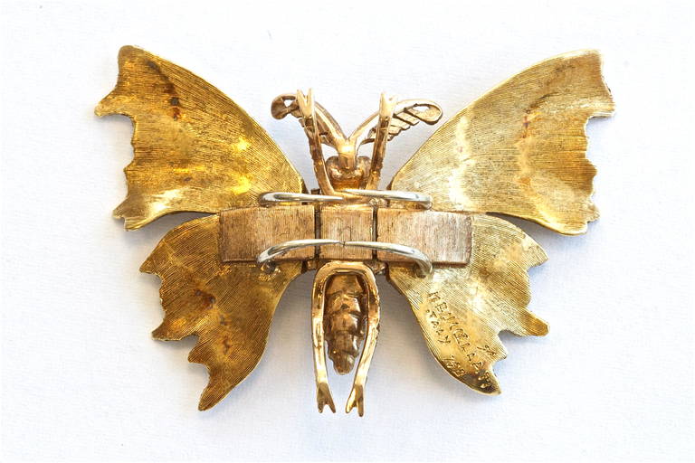 This butterfly brooch displays the textural gold work that Buccellati became famous for and is fashioned with two ruby eyes. Crafted in 18k gold. Signed M. Buccellati.

Mario Buccellati first caught the public's attention when he hurled an