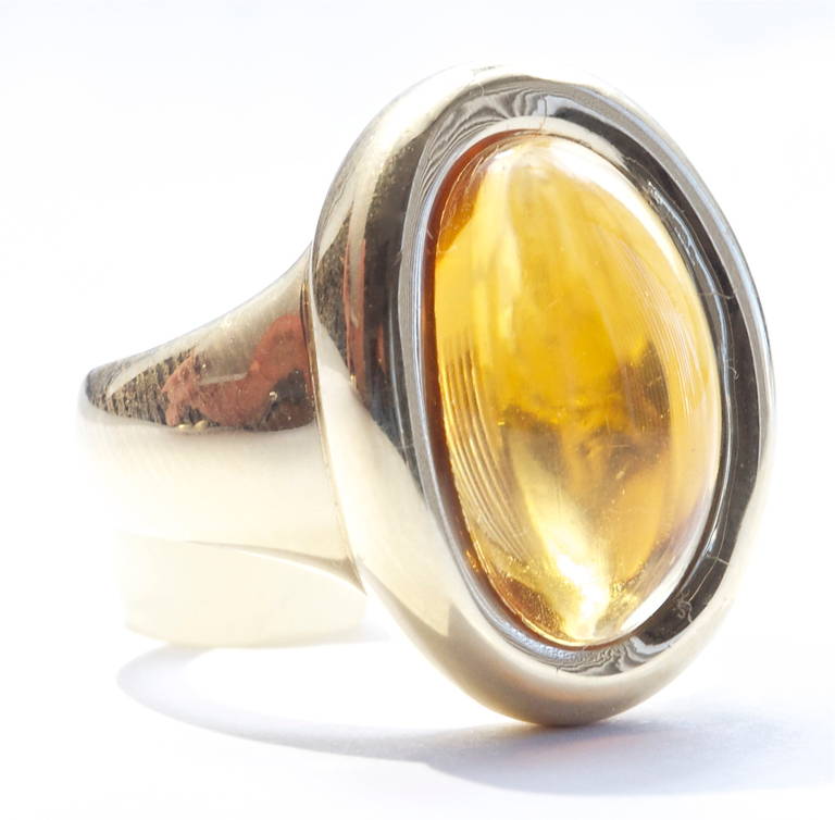 An elegant and refined look from Cartier Paris. The 18k gold ring features a large cabochon golden citrine at the center. Fun and easy to wear. Signed Cartier Paris and stamped with French hallmarks.