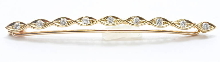A unique Cartier diamond gold barrette. The 9 diamonds are white and well matched.
