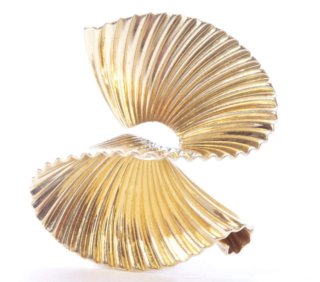 Elegant and swirling earrings created by Tiffany & Co. Crafted in 14k yellow gold.  

Circa 1960