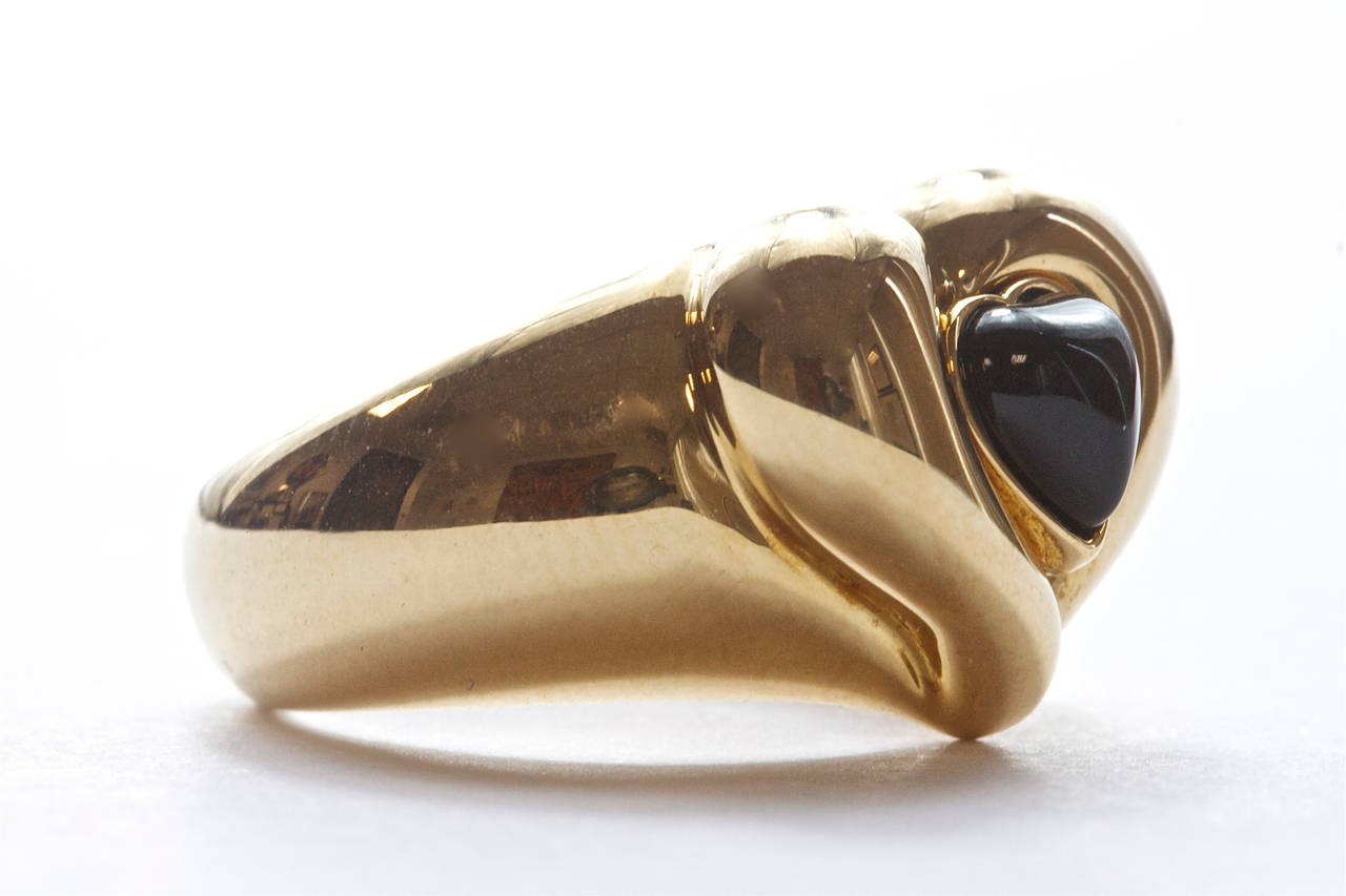 A gracefully shaped heart designed by the French jewelry house Van Cleef and Arpels. Featuring an unusual center cabochon heart shaped onyx. 

Ring size 5 1/4