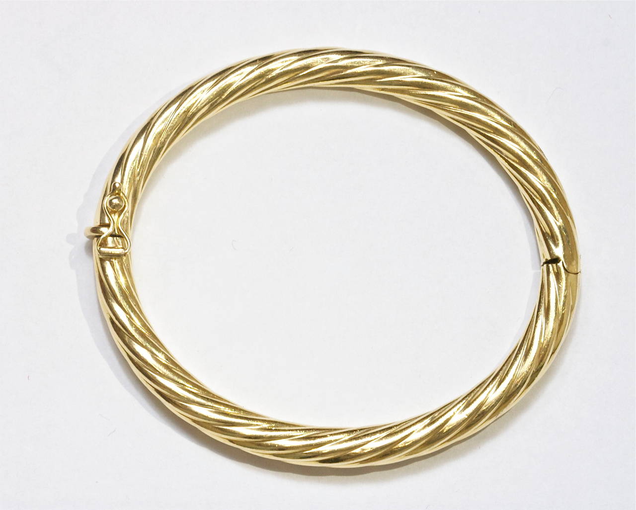 A finely made rope motif bangle bracelet crafted in some of the finest 18k gold Italy is historically known for. 

Stamped T & Co. Italy and weighs 17.84 grams.